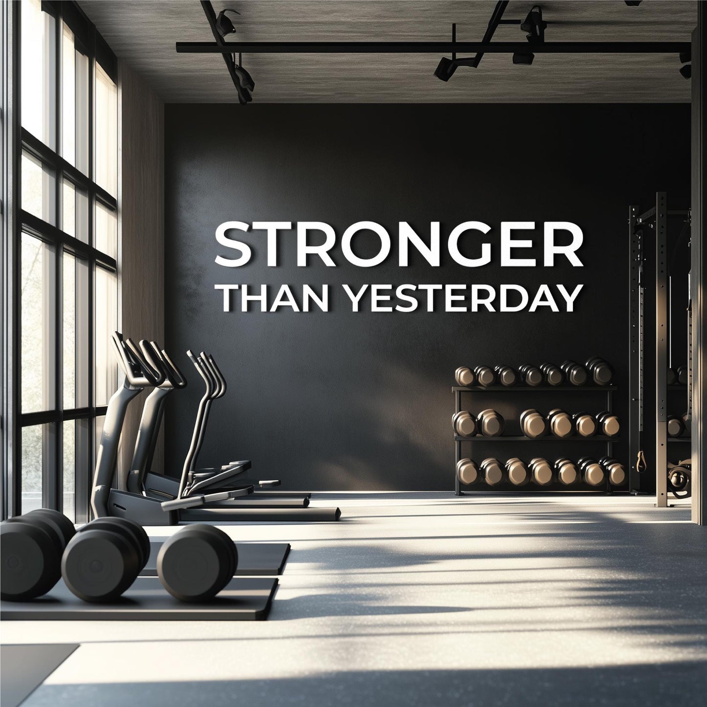 STRONGER THAN YESTERDAY gym wall letters in white PVC 0.5 inch thick installed above dumbbell rack in modern home gym”