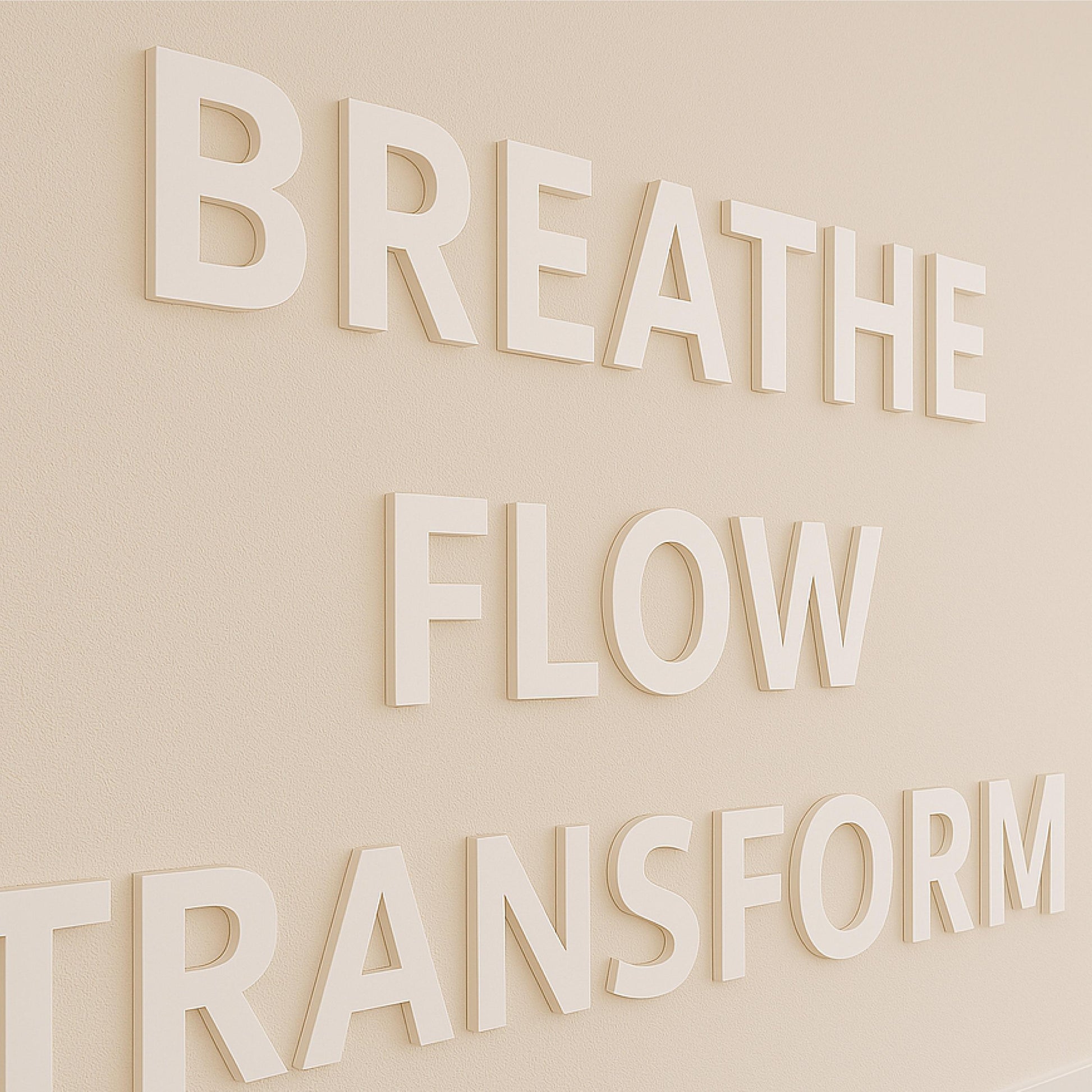 a close up view of 3d letters on the wall of a yoga studio saying BREATHE FLOW TRANSFORM