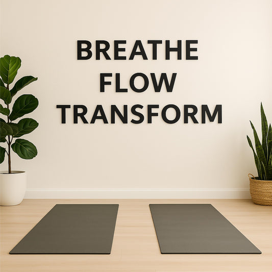 a yoga area with a large sign on the wall saying &#39;BREATHE FLOW TRANSFORM&#39; in black 3d letters