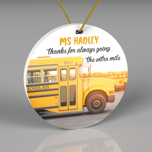 Round Christmas ornament with a realistic yellow school bus. Wording says &quot;thanks for always going the extra mile&quot;